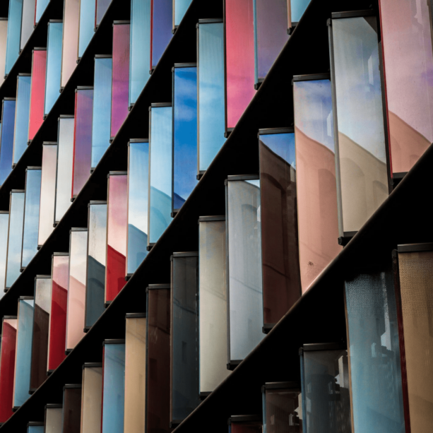 This image shows a building with controlled vertical window shutters