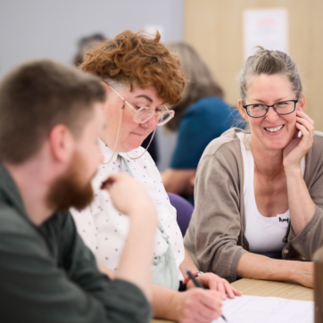 This image shows three people sitting at a table
