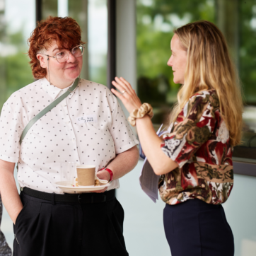 This image shows two people standing out side talking