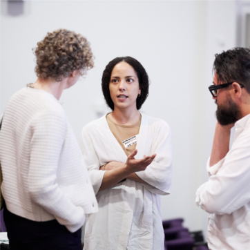 This image shows three people talking