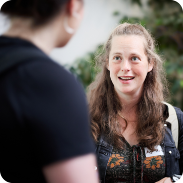 This image shows two people talking