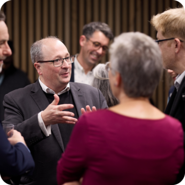 A small group of people talking at a professional event.