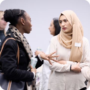 Two people talking at a professional event