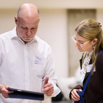 Two people looking at an iPad.