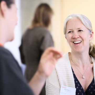 A woman smiling during a conversation.