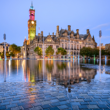 Bradford's Centenary Square and fountain at dusk.