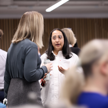 Two women stood talking at an event.